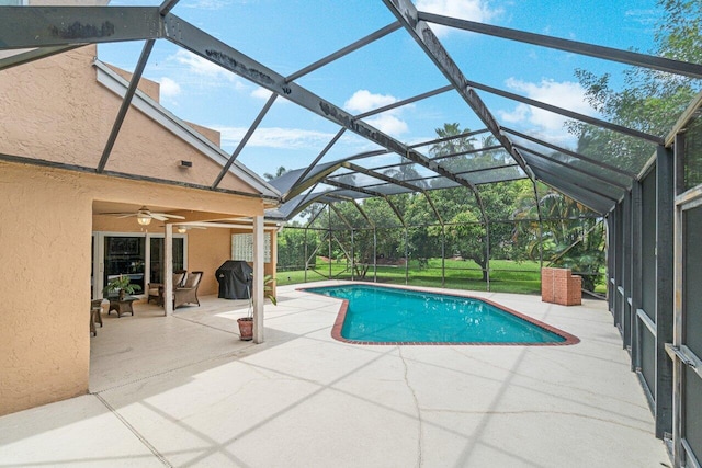 22075 Flower Dr, Boca Raton, FL 33428 - outdoor pool with a patio area, ceiling fan, a grill, and glass enclosure