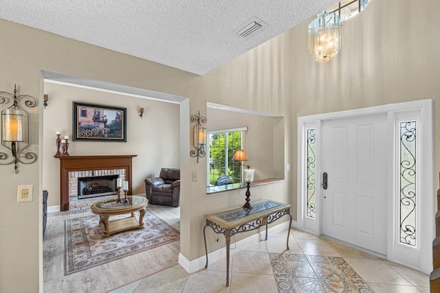 22075 Flower Dr, Boca Raton, FL 33428 - tiled entrance foyer featuring a textured ceiling, a brick fireplace, a high ceiling, and baseboards