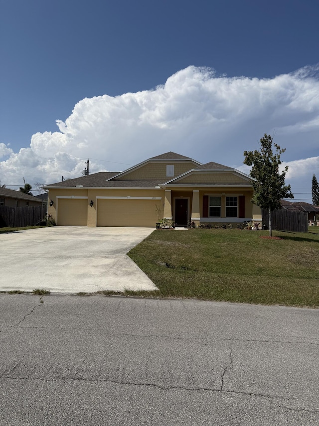 2313 SW Neal Rd, Port Saint Lucie, FL 34953 - view of front of home featuring an attached garage, driveway, and stucco siding