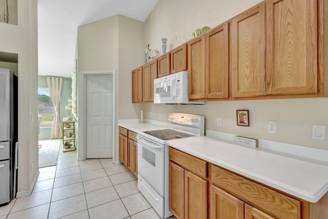 1985 SW Beard St, Port Saint Lucie, FL 34953 - kitchen with white appliances, light tile patterned floors, and light countertops