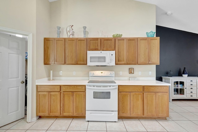 1985 SW Beard St, Port Saint Lucie, FL 34953 - kitchen featuring white appliances, light tile patterned floors, and light countertops