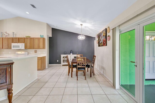 1985 SW Beard St, Port Saint Lucie, FL 34953 - dining space with lofted ceiling, light tile patterned floors, baseboards, and french doors