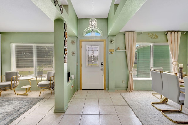 1985 SW Beard St, Port Saint Lucie, FL 34953 - foyer entrance featuring light tile patterned flooring, a chandelier, and plenty of natural light