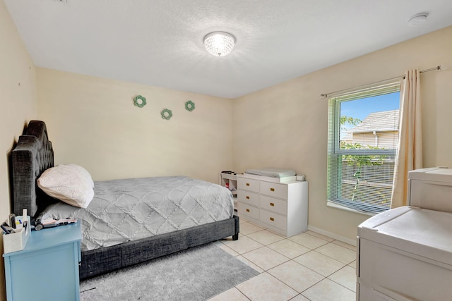 1985 SW Beard St, Port Saint Lucie, FL 34953 - bedroom with light tile patterned flooring, baseboards, and washer / clothes dryer