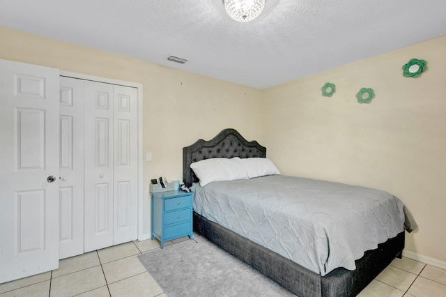 1985 SW Beard St, Port Saint Lucie, FL 34953 - bedroom with tile patterned flooring, a closet, a textured ceiling, and baseboards
