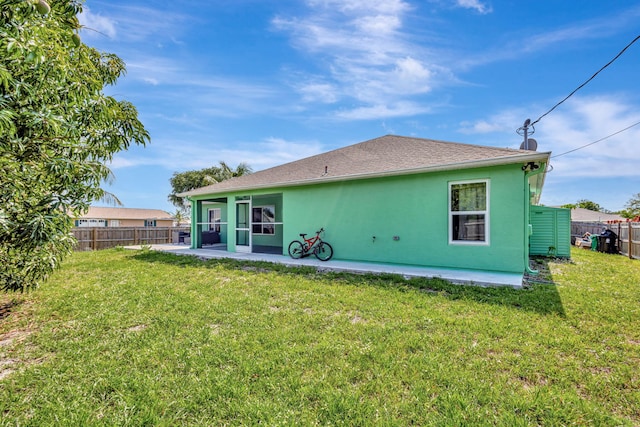 1985 SW Beard St, Port Saint Lucie, FL 34953 - back of property with stucco siding and a patio area