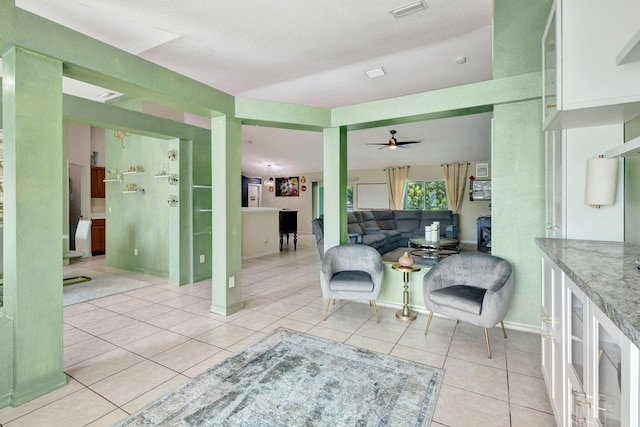 1985 SW Beard St, Port Saint Lucie, FL 34953 - living area featuring light tile patterned floors, a ceiling fan, and baseboards