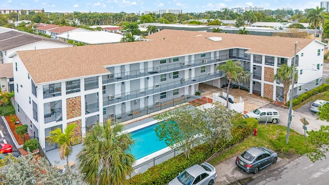 drone / aerial view of apartment complex and a pool