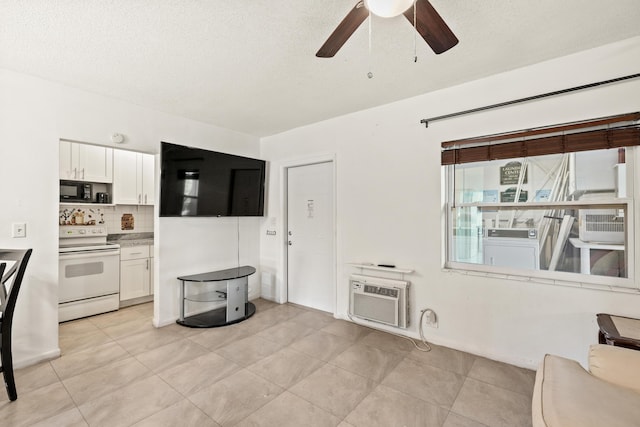 unfurnished living room featuring ceiling fan, an AC wall unit, light tile patterned floors, and a textured ceiling