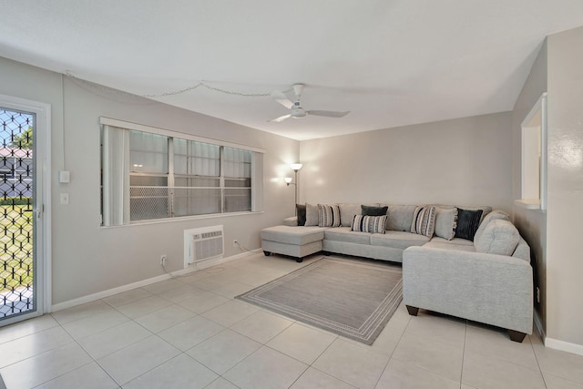 tiled living room with a ceiling fan, baseboards, and a wall mounted air conditioner