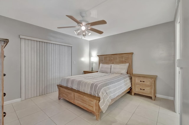 bedroom featuring light tile patterned floors, a ceiling fan, and baseboards