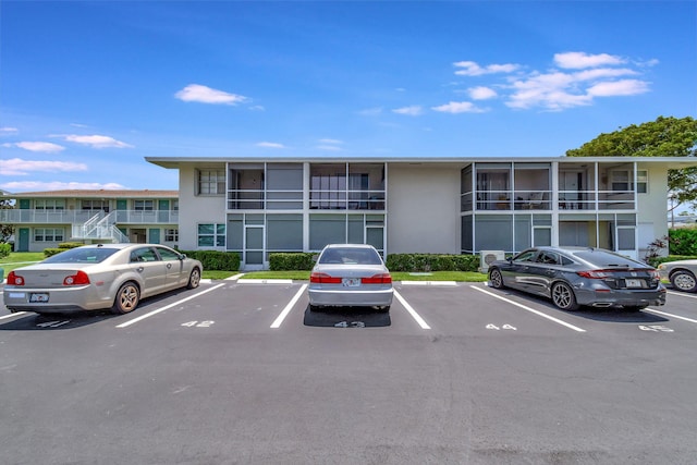 view of building exterior featuring uncovered parking