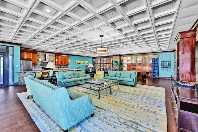 living room featuring coffered ceiling, dark wood-style floors, and crown molding