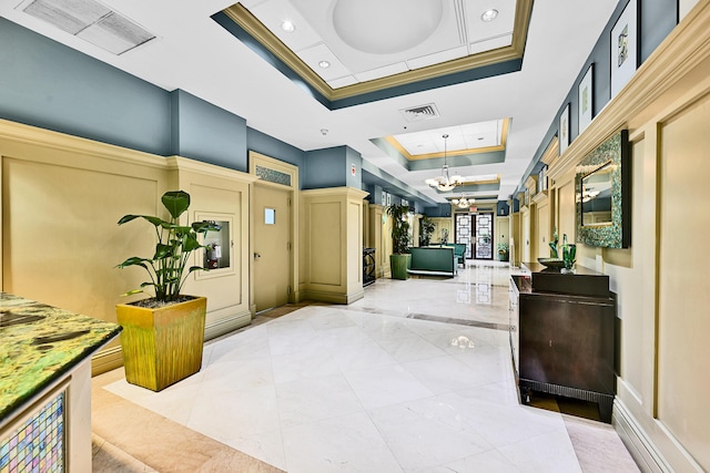 community lobby with a decorative wall, recessed lighting, and crown molding