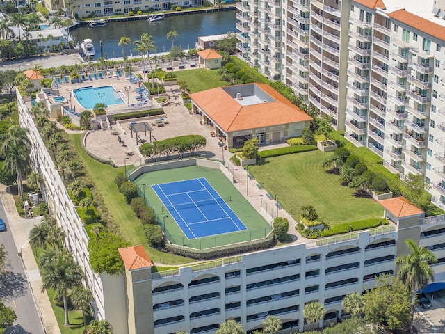 aerial view of a large body of water, a pool, and apartment complex / building