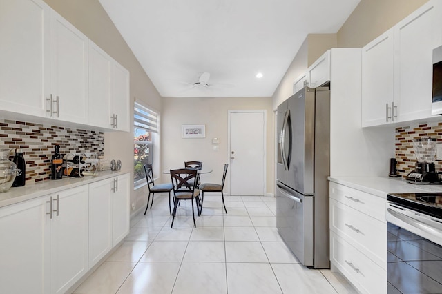 kitchen featuring appliances with stainless steel finishes, a ceiling fan, white cabinets, decorative backsplash, and light countertops