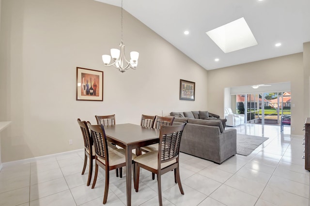 dining area with high vaulted ceiling, a chandelier, light tile patterned floors, a skylight, and recessed lighting