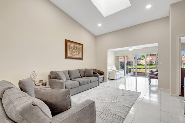 living area with high vaulted ceiling, light tile patterned floors, baseboards, recessed lighting, and a skylight