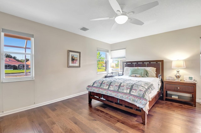 bedroom featuring wood finished floors, baseboards, and ceiling fan