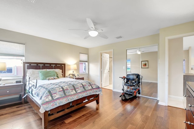 bedroom featuring wood finished floors, a ceiling fan, and baseboards