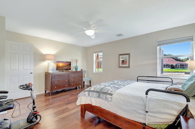 bedroom featuring wood finished floors, ceiling fan, and baseboards