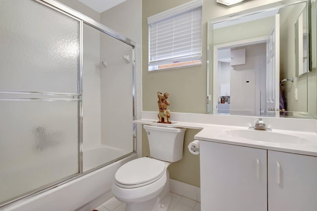 bathroom featuring vanity, tile patterned floors, enclosed tub / shower combo, and toilet