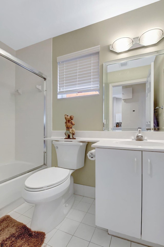 full bath featuring toilet, tile patterned floors, vanity, and shower / bath combination with glass door
