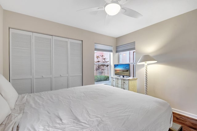bedroom featuring wood finished floors, a closet, baseboards, and a ceiling fan