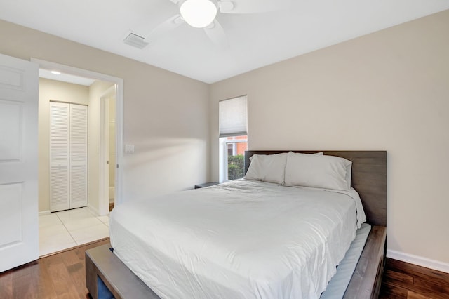 bedroom with wood finished floors, baseboards, and a ceiling fan