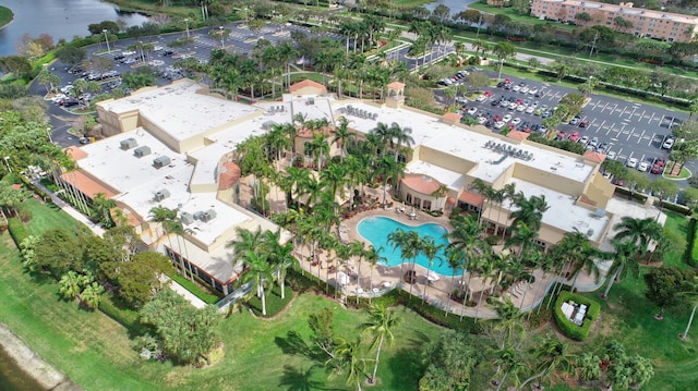 aerial view of property's location with a pool and a large body of water
