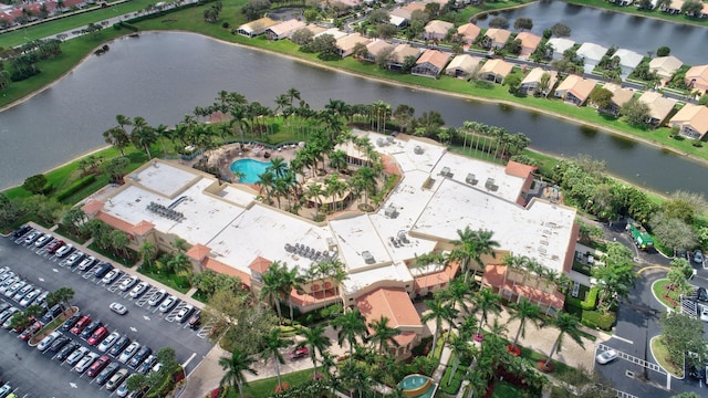 aerial overview of property's location featuring a nearby body of water and a pool