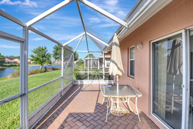 sunroom / solarium featuring a water view