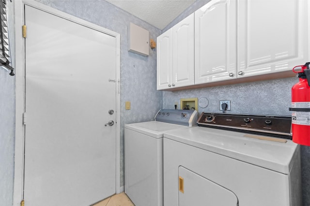 6120 Kings Gate Cir, Delray Beach, FL 33484 - laundry room featuring cabinet space, washer and dryer, a textured ceiling, and light tile patterned floors