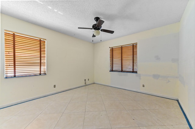 6120 Kings Gate Cir, Delray Beach, FL 33484 - tiled empty room with ceiling fan, baseboards, and a textured ceiling