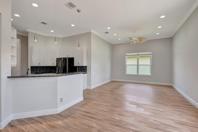 kitchen with freestanding refrigerator, crown molding, ceiling fan, white cabinetry, and light wood-type flooring