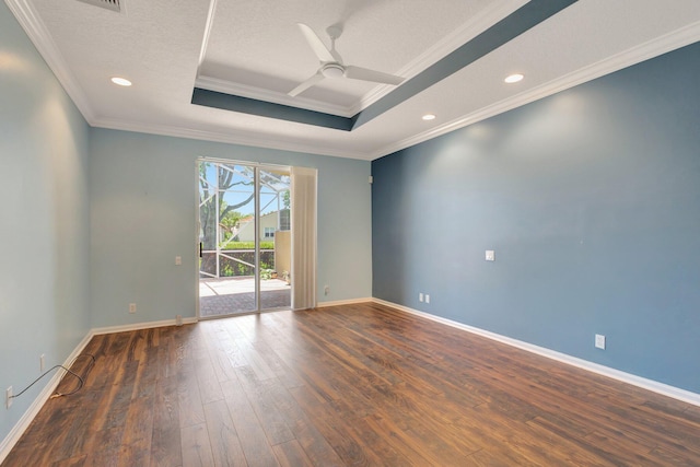 unfurnished room with a raised ceiling, hardwood / wood-style flooring, ornamental molding, a ceiling fan, and baseboards