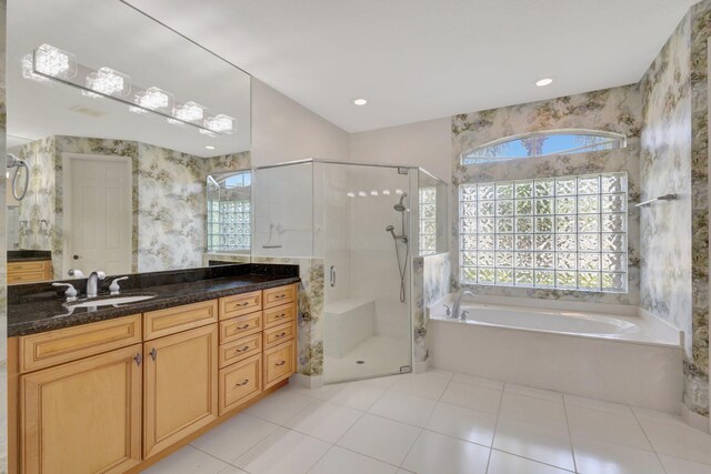full bathroom with a bath, vanity, healthy amount of natural light, and a stall shower