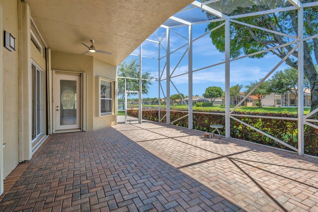view of patio / terrace featuring a lanai and ceiling fan