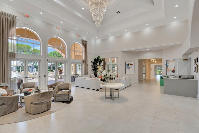 building lobby with a towering ceiling, recessed lighting, and ornamental molding