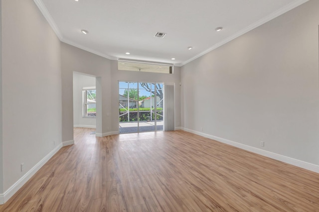 empty room featuring baseboards, light wood-style flooring, crown molding, and recessed lighting