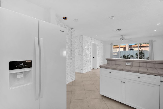 2230 NE 62nd St, Fort Lauderdale, FL 33308 - kitchen featuring white refrigerator with ice dispenser, tile counters, white cabinetry, a ceiling fan, and light tile patterned flooring