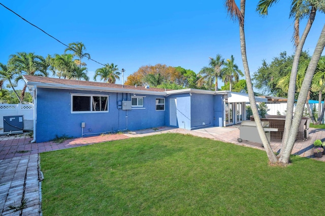 2230 NE 62nd St, Fort Lauderdale, FL 33308 - back of property with stucco siding and a patio area