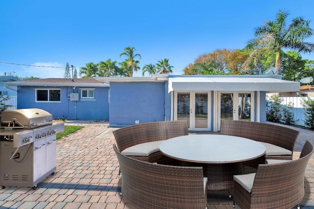 2230 NE 62nd St, Fort Lauderdale, FL 33308 - view of patio featuring french doors, outdoor dining area, and a grill