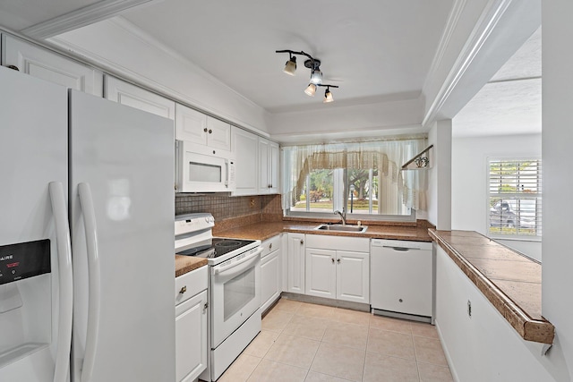 kitchen featuring white appliances, light tile patterned floors, a sink, white cabinetry, and tasteful backsplash