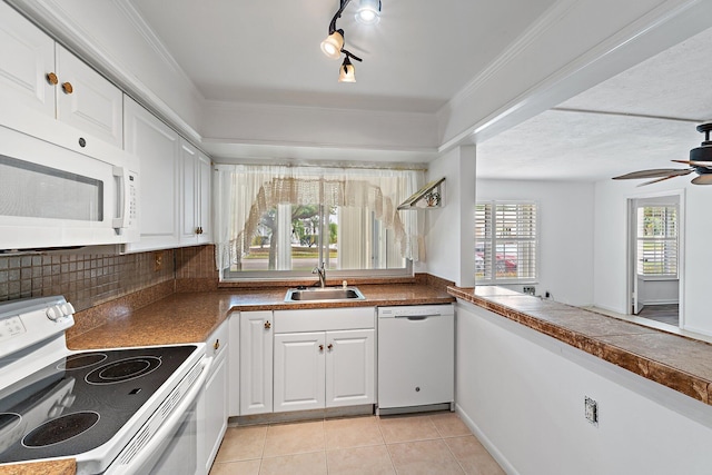 kitchen featuring white appliances, a sink, white cabinetry, and light tile patterned floors