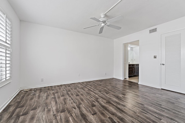 spare room with a ceiling fan, wood finished floors, and baseboards
