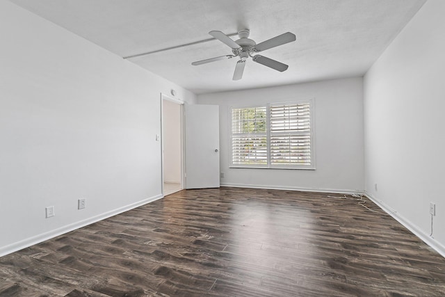 empty room featuring wood finished floors, a ceiling fan, and baseboards