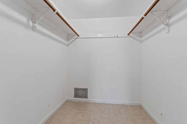 spacious closet featuring light tile patterned floors