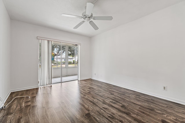 spare room with wood finished floors, a ceiling fan, and baseboards