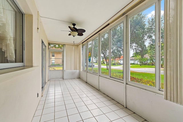 unfurnished sunroom with a ceiling fan